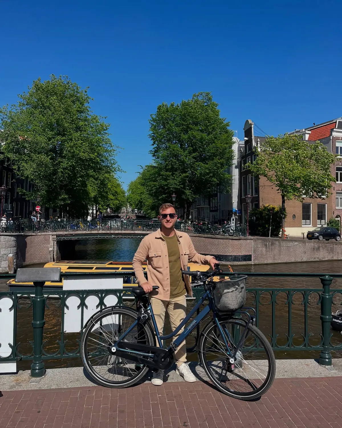 Andrew with a rental bike on a canal bridge in Amsterdam