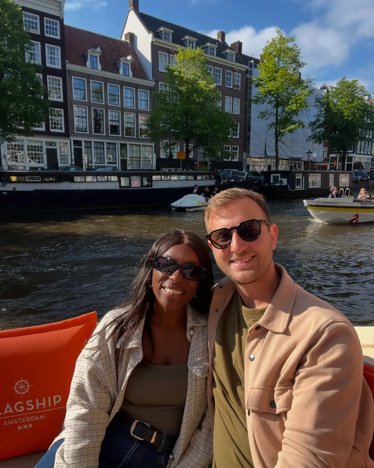 A selfie of us on a canal cruise boat gliding past Amsterdam's canal houses