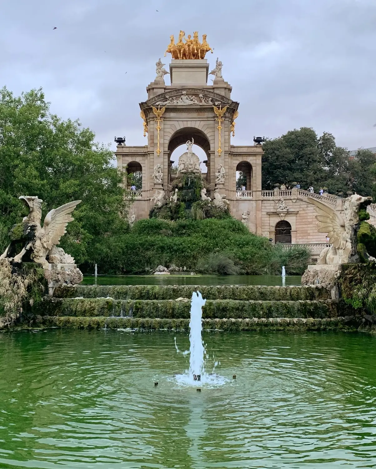 The golden Cascada Monumental fountain and green pond in Parc de la Ciutadella, Barcelona