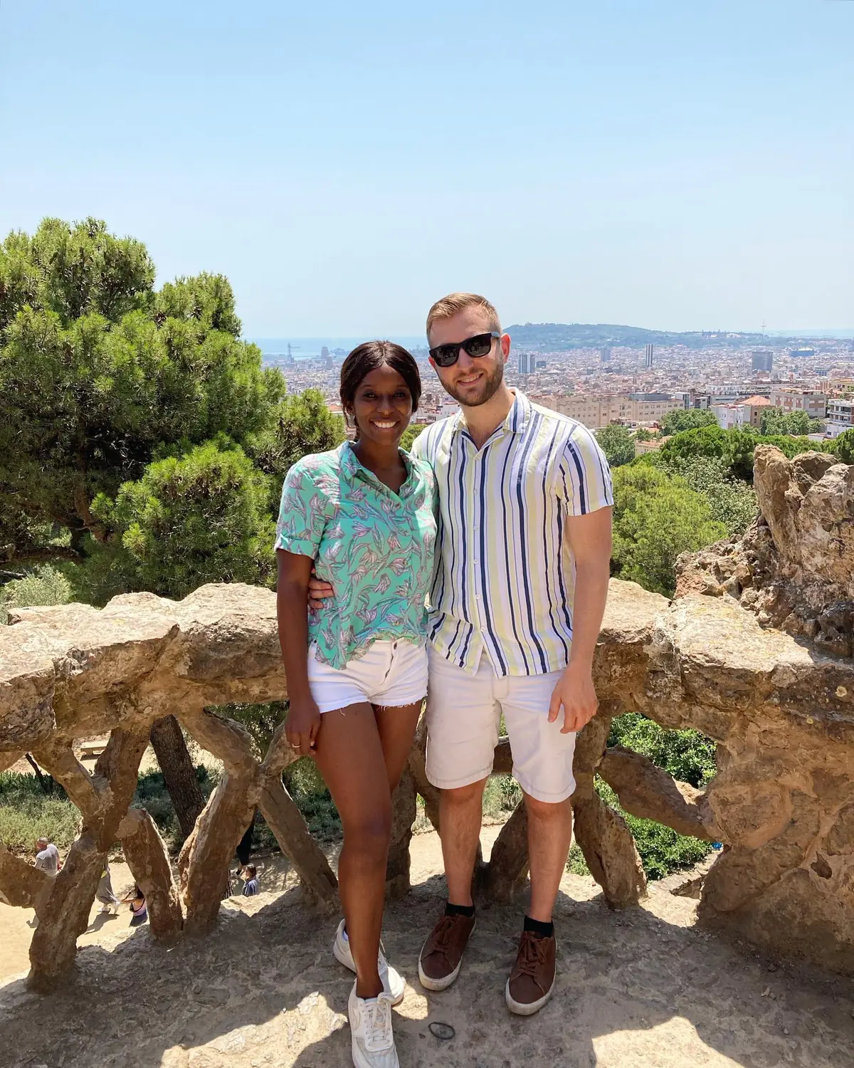 Us at a Park Güell viewpoint with the city and sea stretching out behind