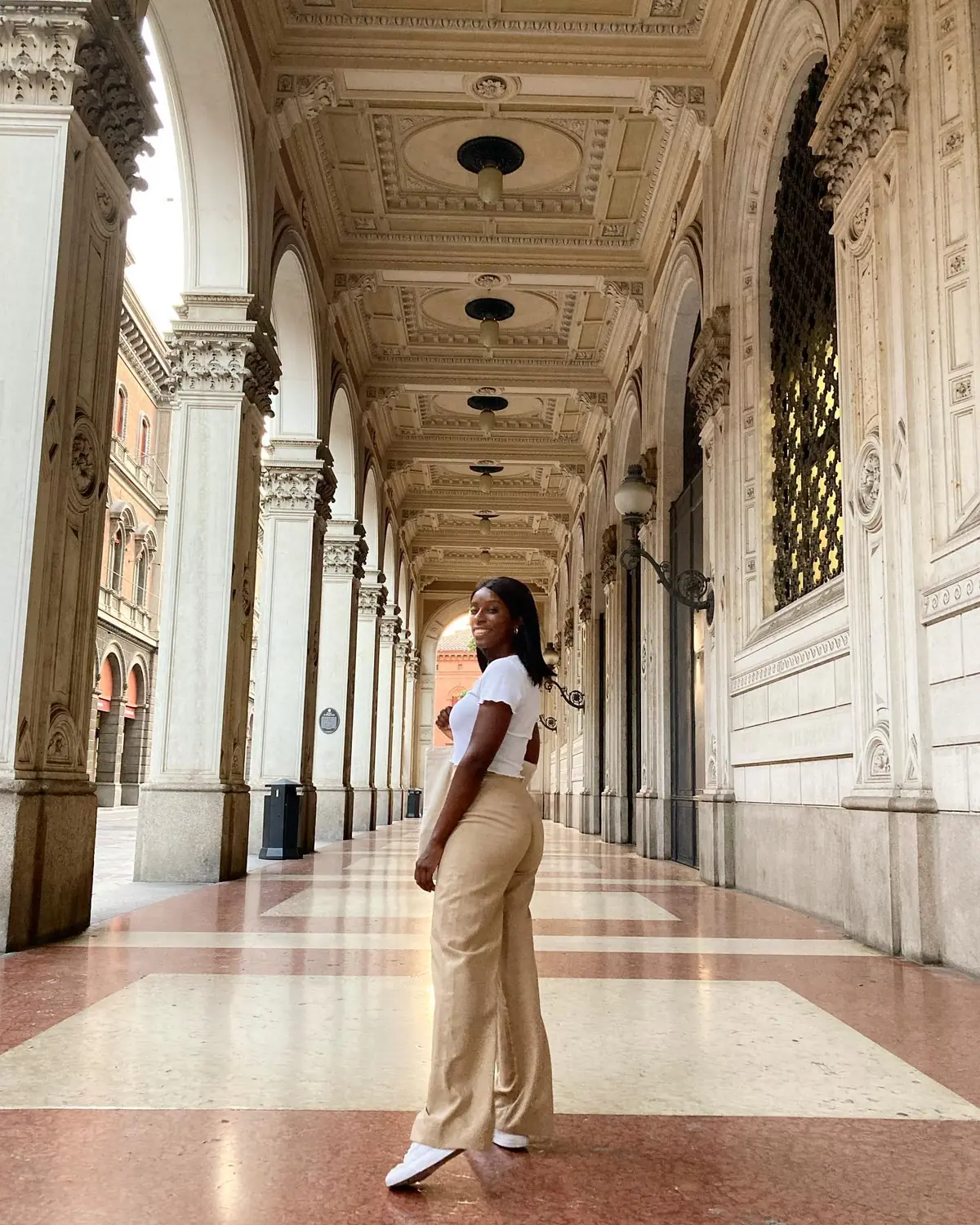 Melody under one of Bologna's grand porticoed arcades with a coffered ceiling