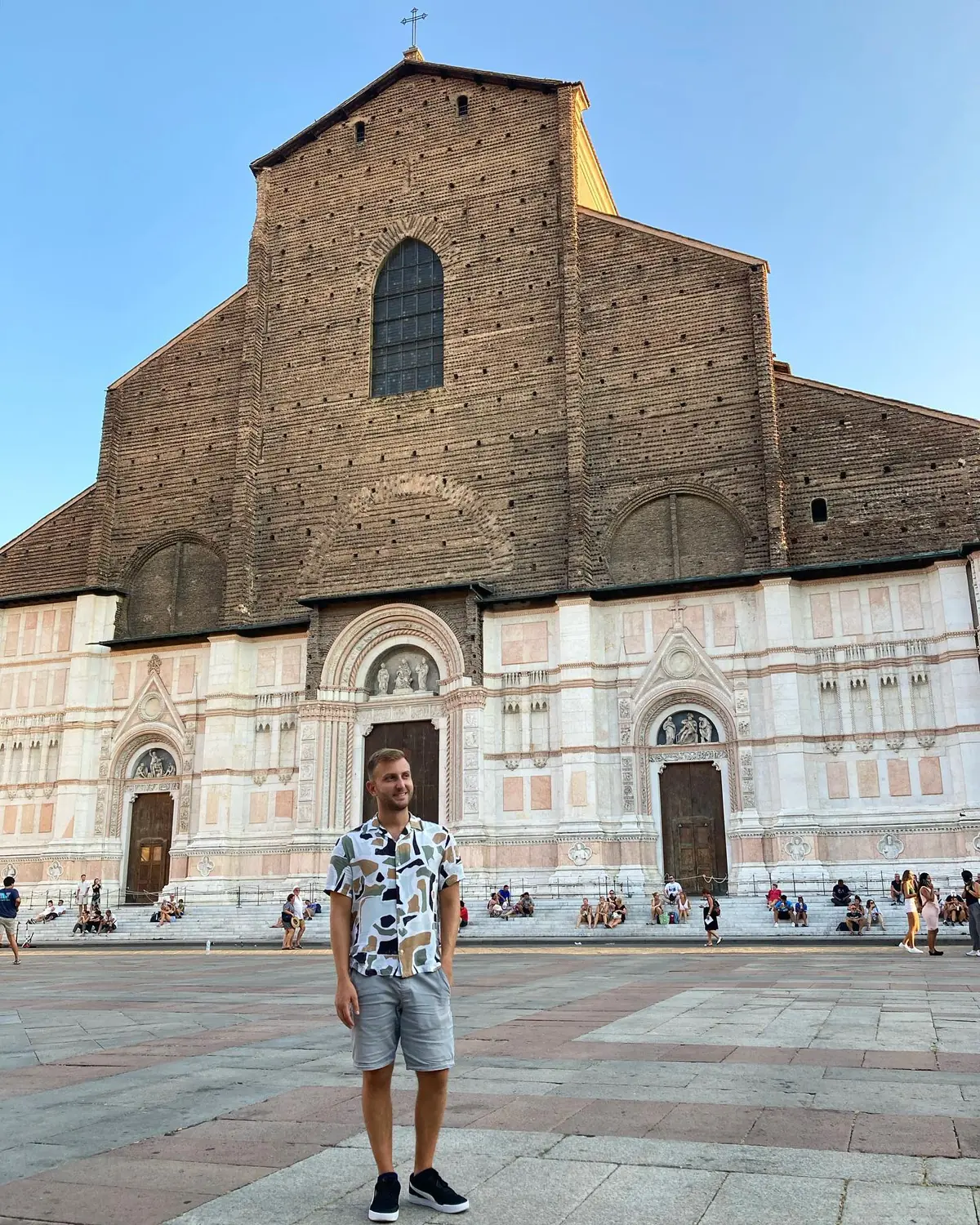 Andrew in front of the half-finished marble-and-brick facade of San Petronio