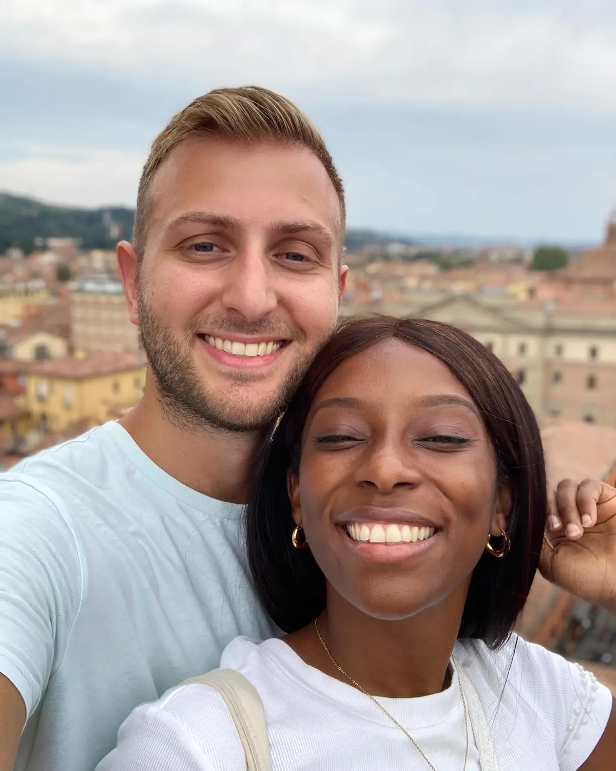Us on a rooftop with Bologna's rooftops and hills spread out behind