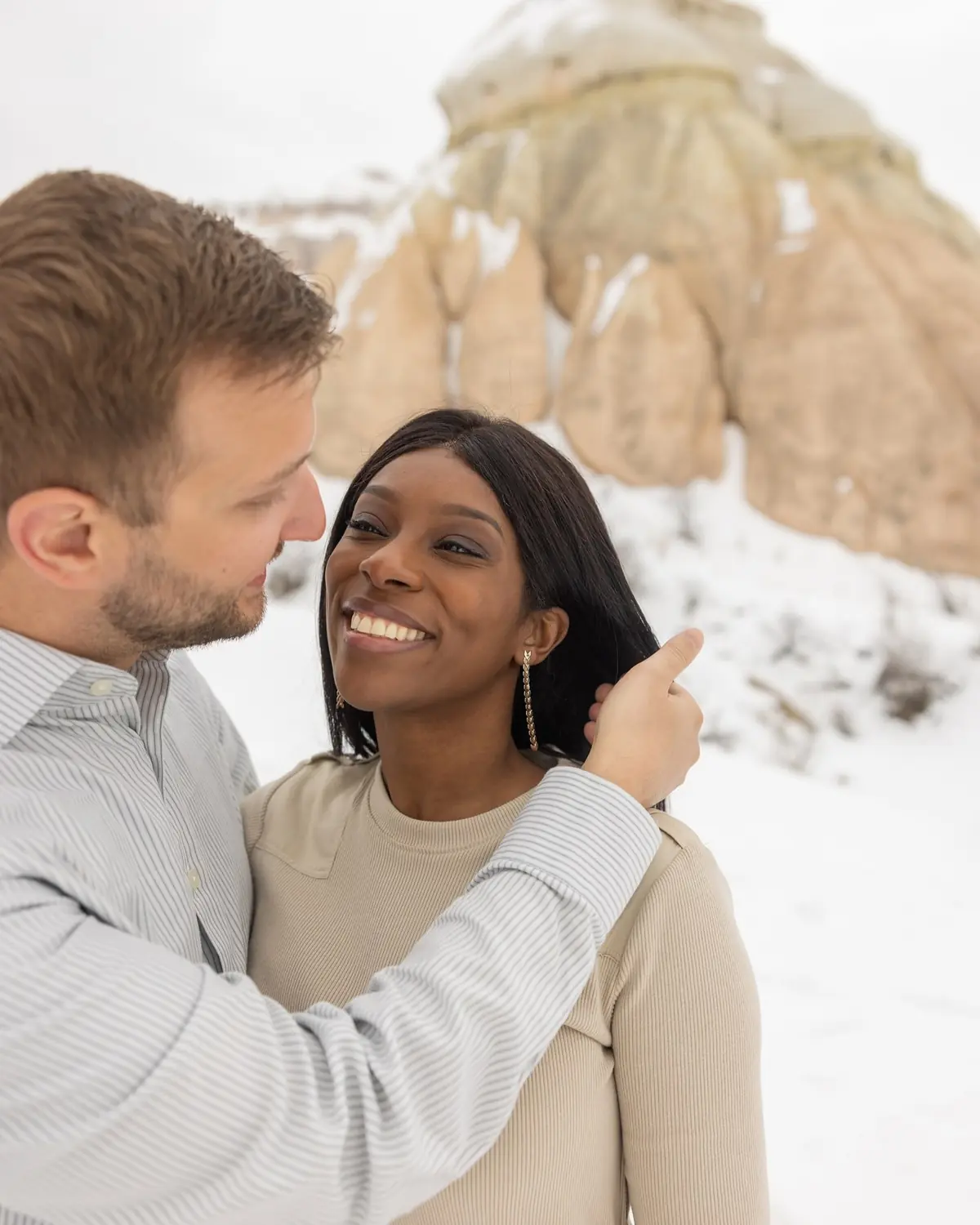 Andrew touching Melody's face in the snow