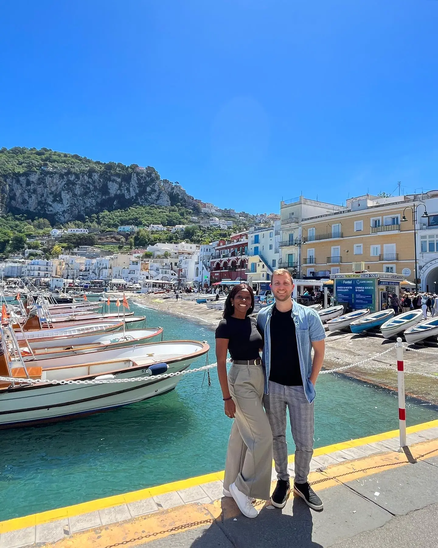 Us at Marina Grande harbour with the fishing boats and pastel buildings