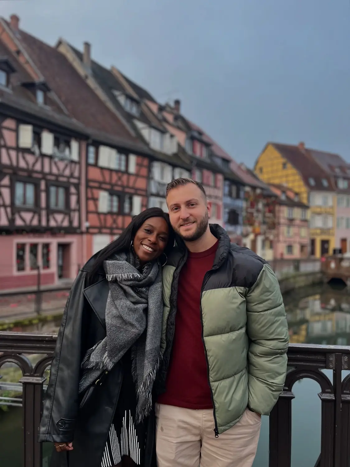 A close-up of us on the Colmar canal bridge with the pastel Little Venice houses behind