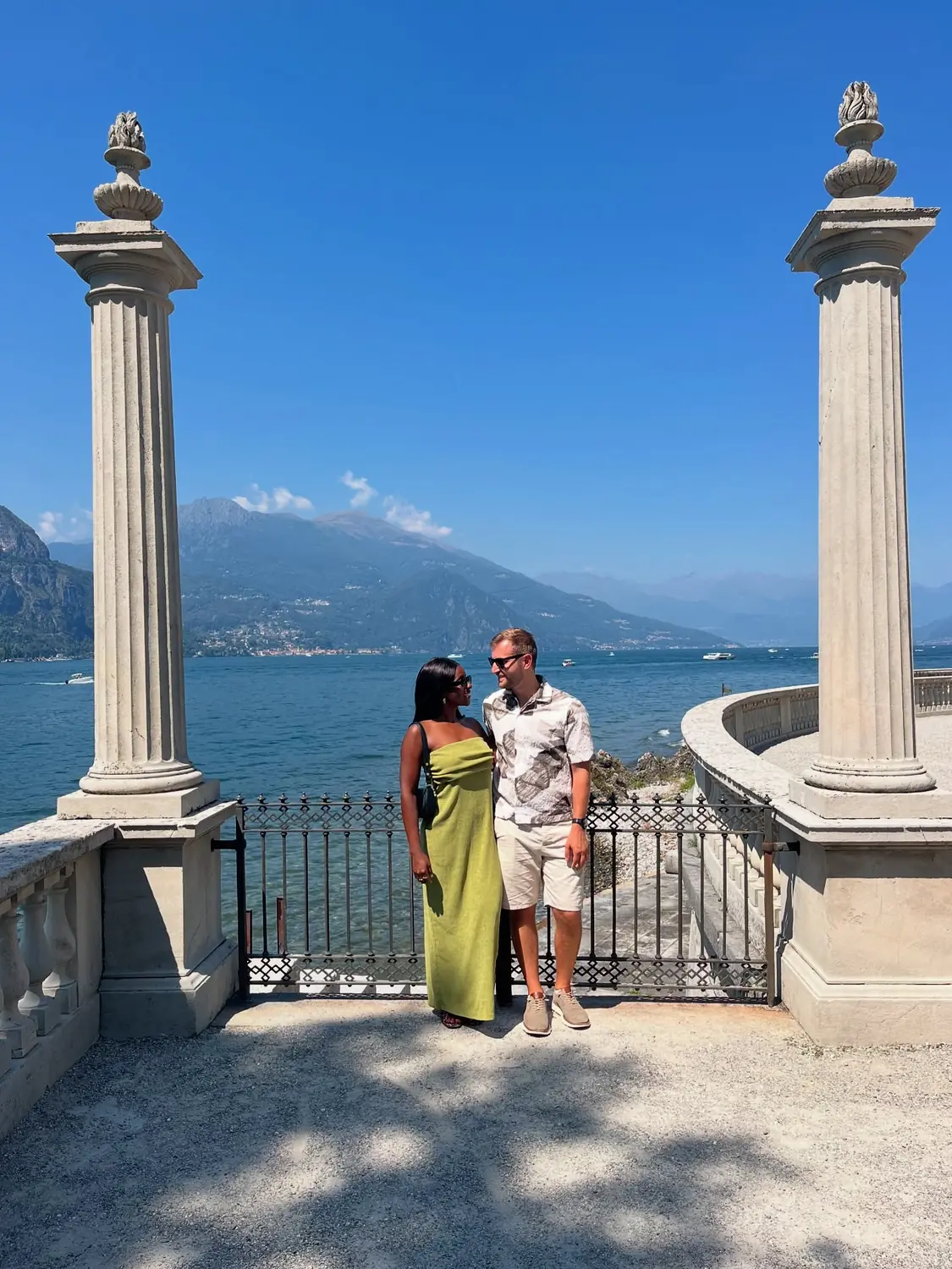 Us between stone columns on a villa terrace