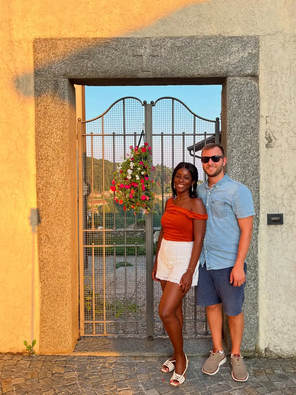 Us by a golden-hour gate in the village