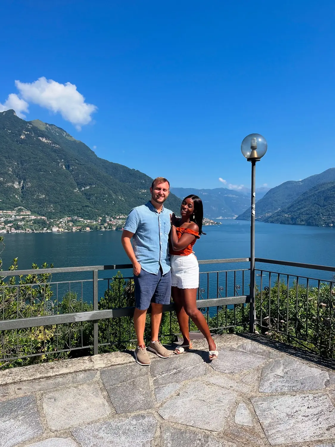 Us at a railed belvedere over the lake