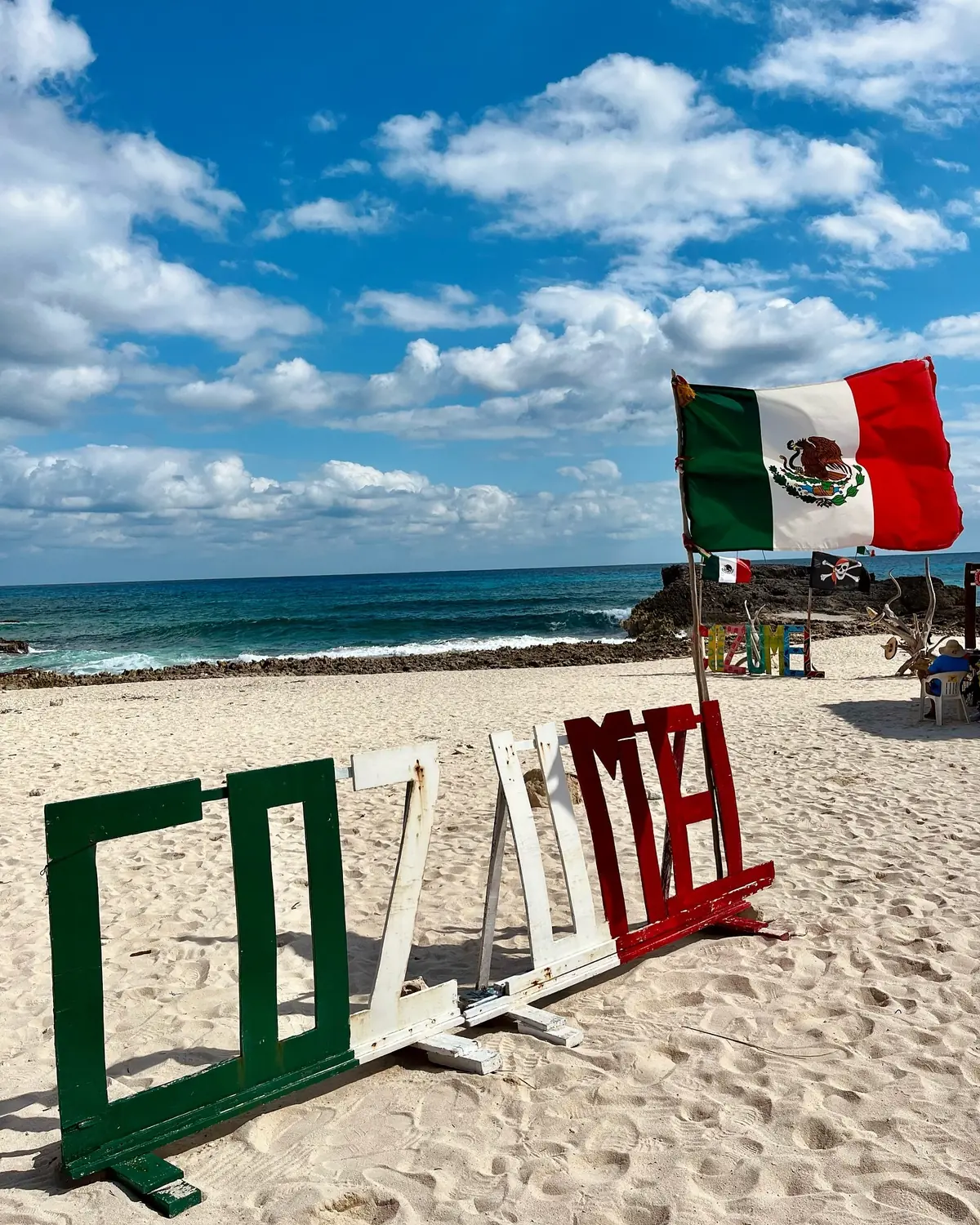 Cozumel beach sign with Mexican flag