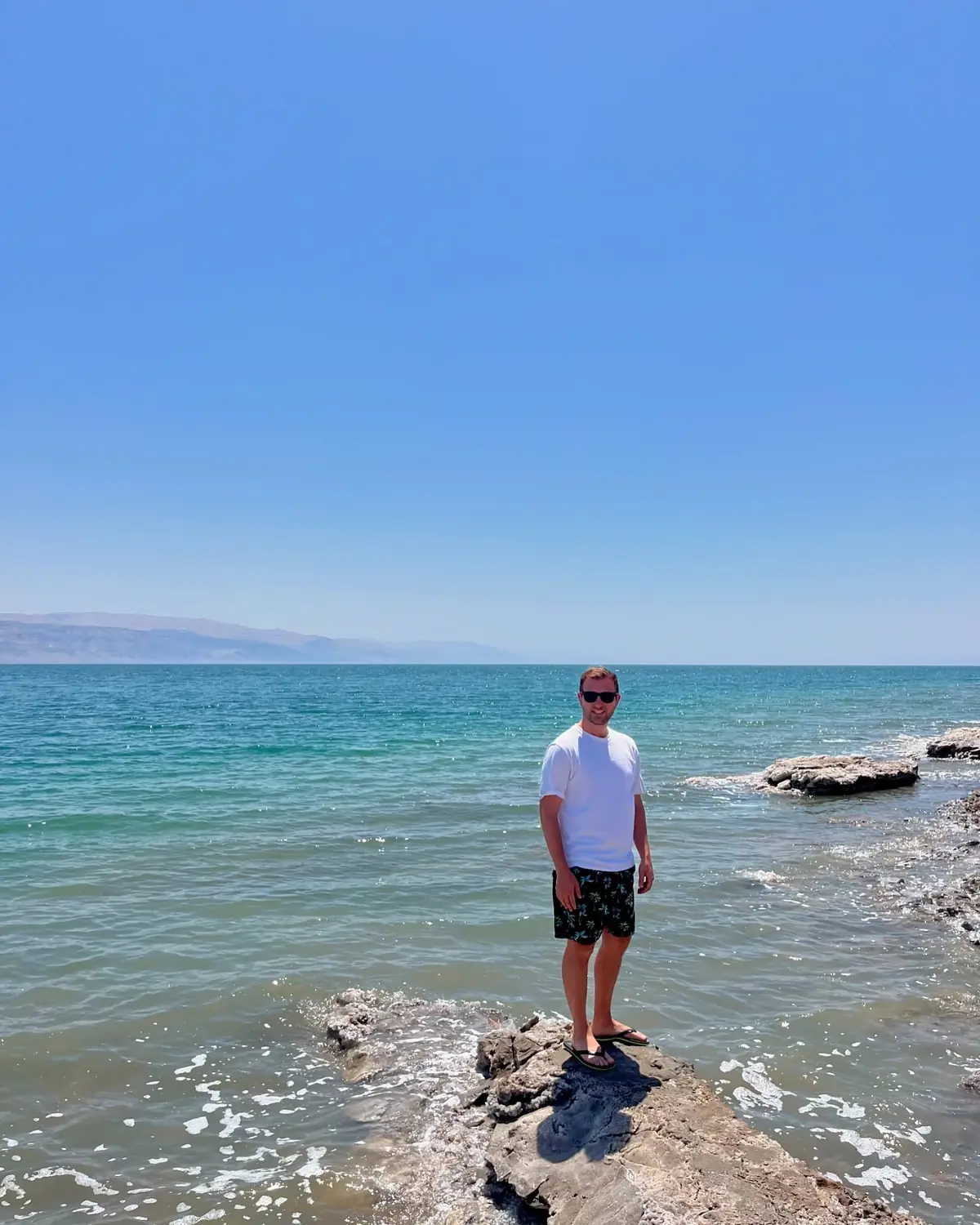 Andrew on a rock at the Dead Sea