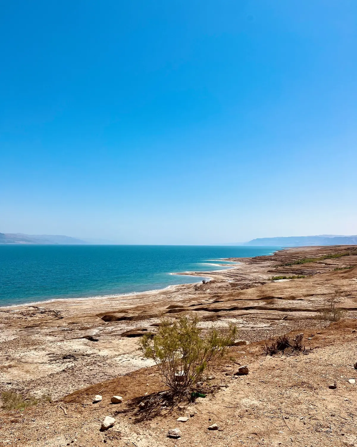 The turquoise water and salt shore of the Dead Sea