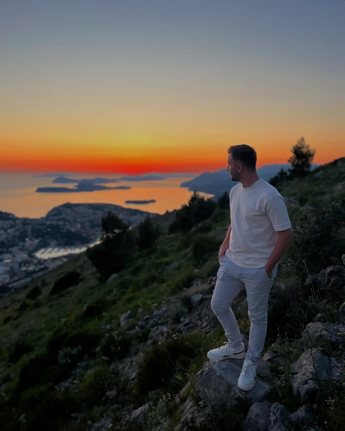 Us on the grassy top of Mount Srđ with Dubrovnik's Old Town far below by the sea