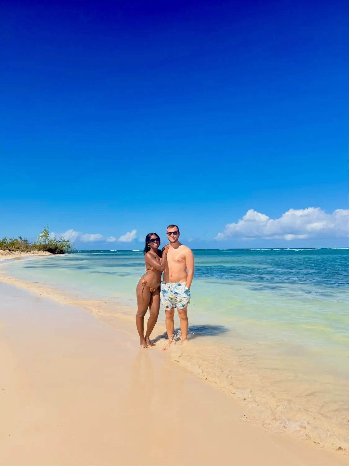 Us on a Falmouth beach with crystal-clear turquoise water