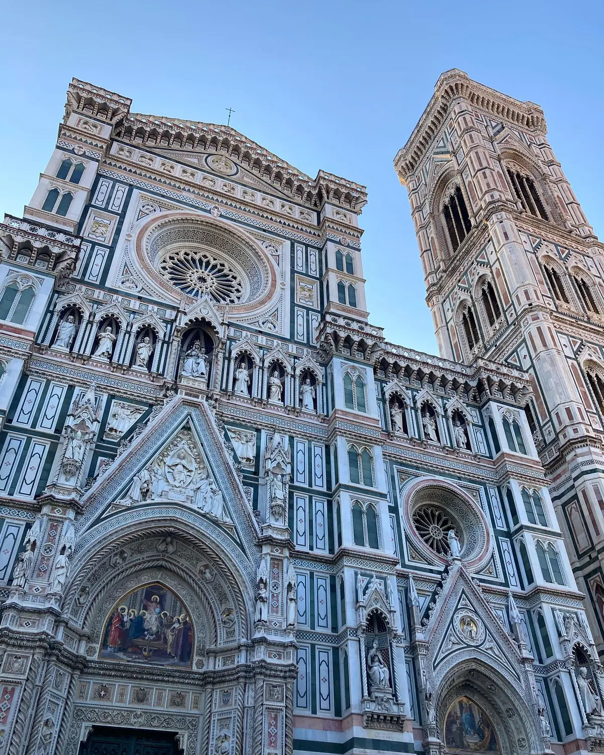 The multicoloured marble facade of Florence Cathedral and Giotto's bell tower