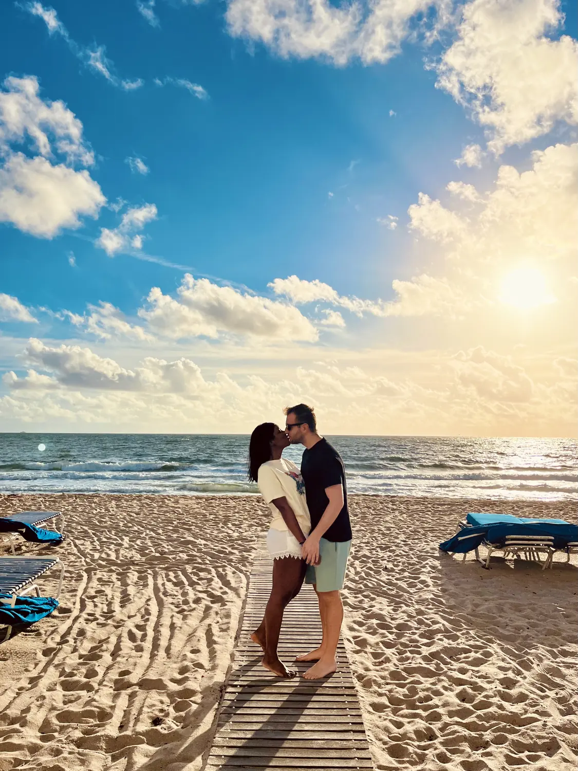 Us embracing on Fort Lauderdale beach in golden evening light