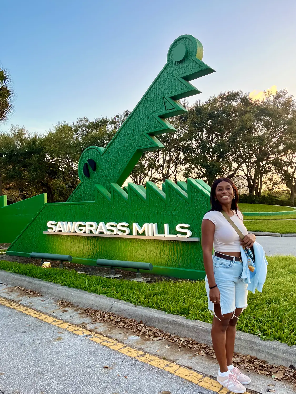 Melody by the giant green alligator Sawgrass Mills sign near Fort Lauderdale