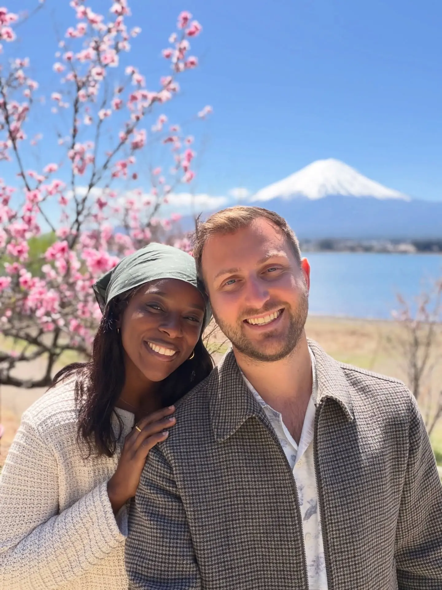 A selfie with Mount Fuji and pink blossoms behind us