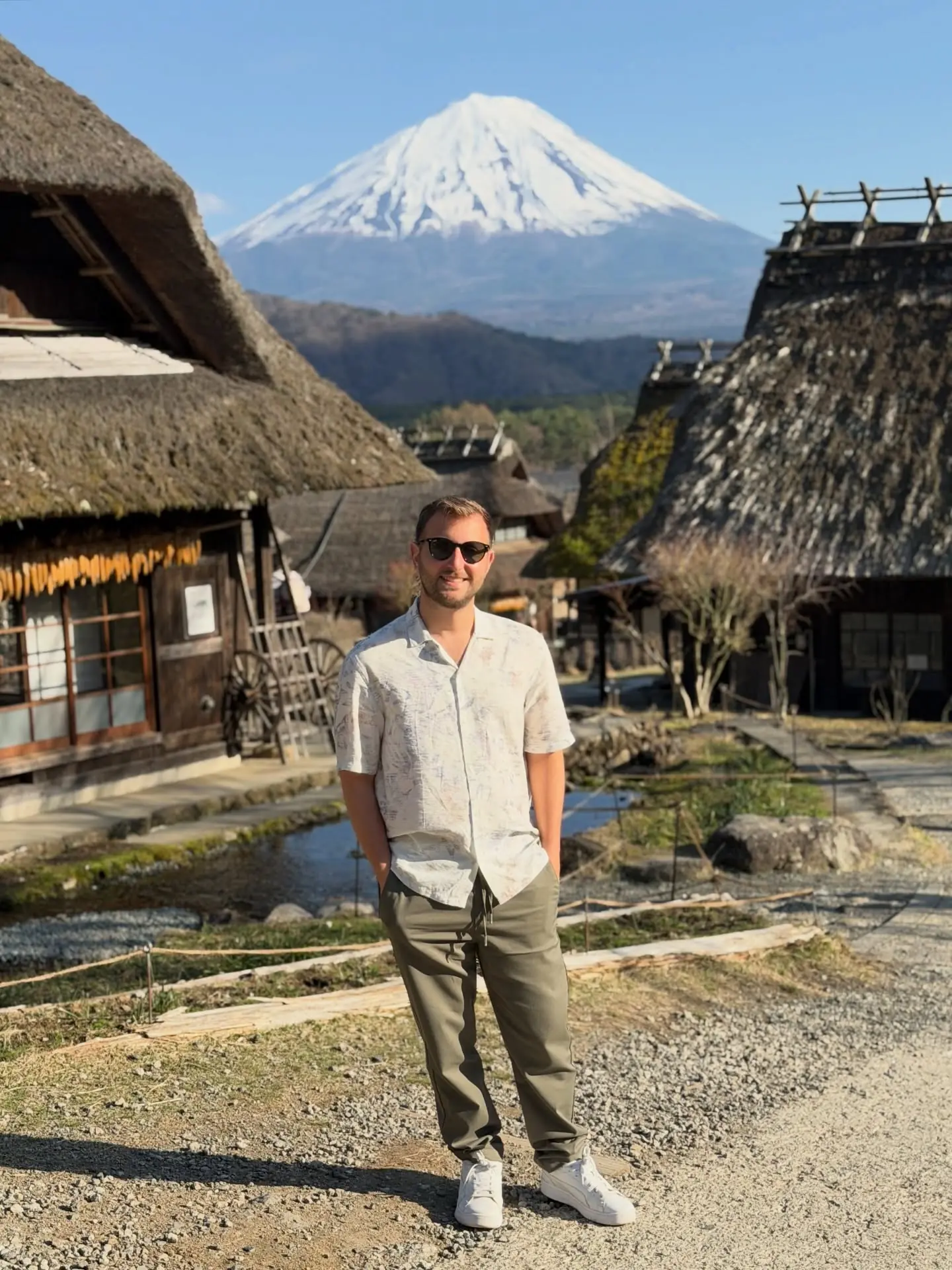 Andrew at the thatched village with Mount Fuji behind