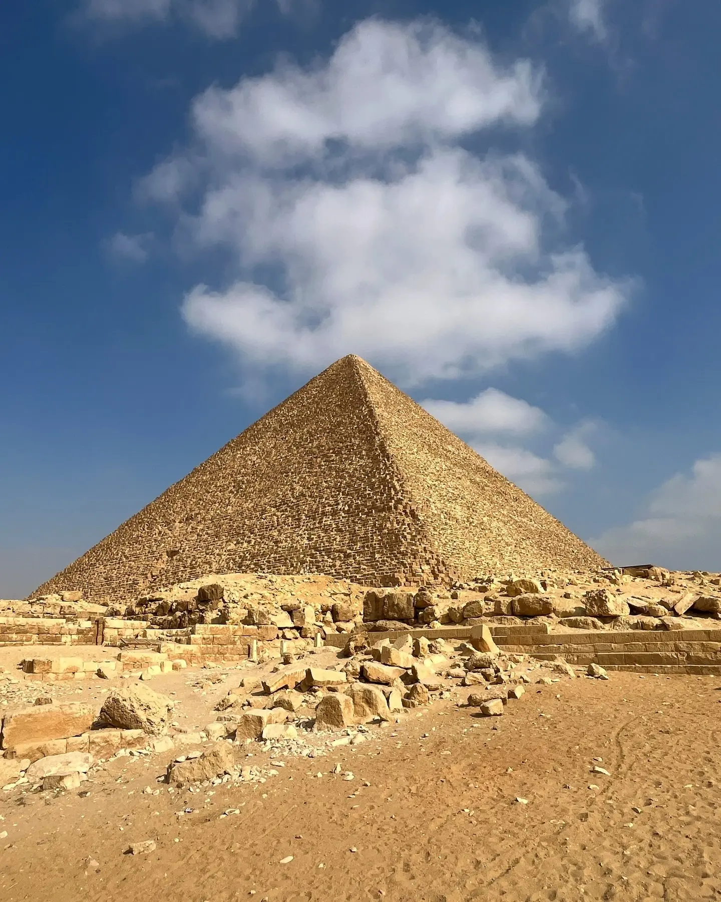 The Great Pyramid of Khufu towering against a blue sky