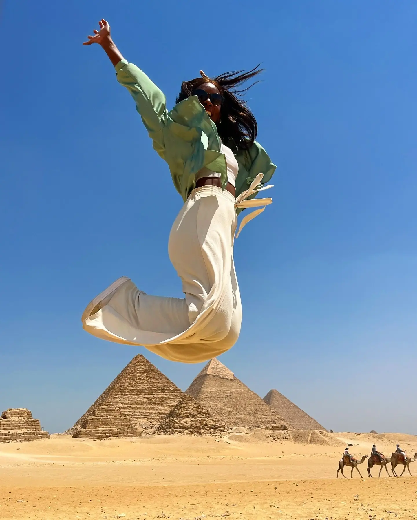 Jumping for joy in front of the pyramids of Giza