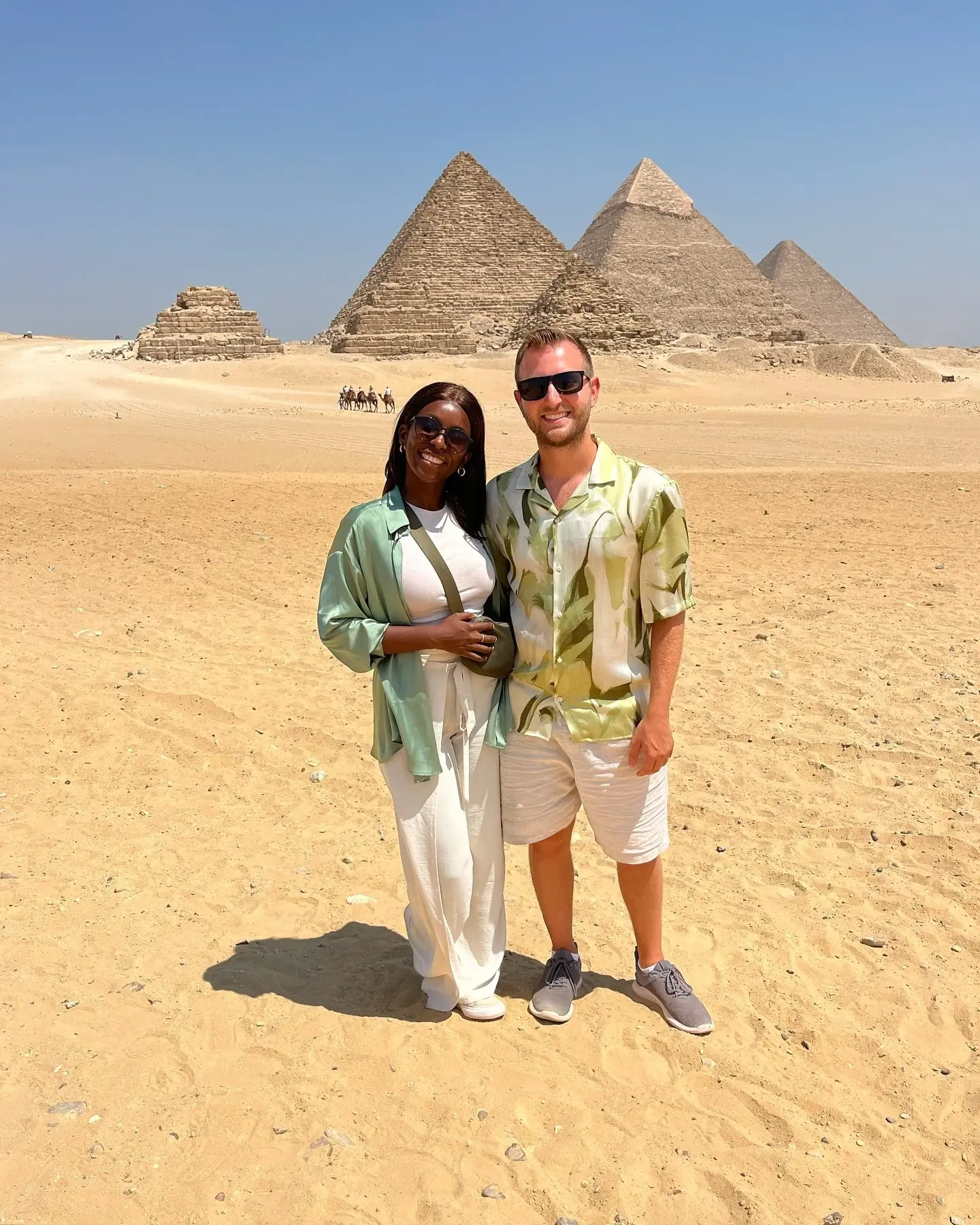 Couple with all three Giza pyramids lined up behind them