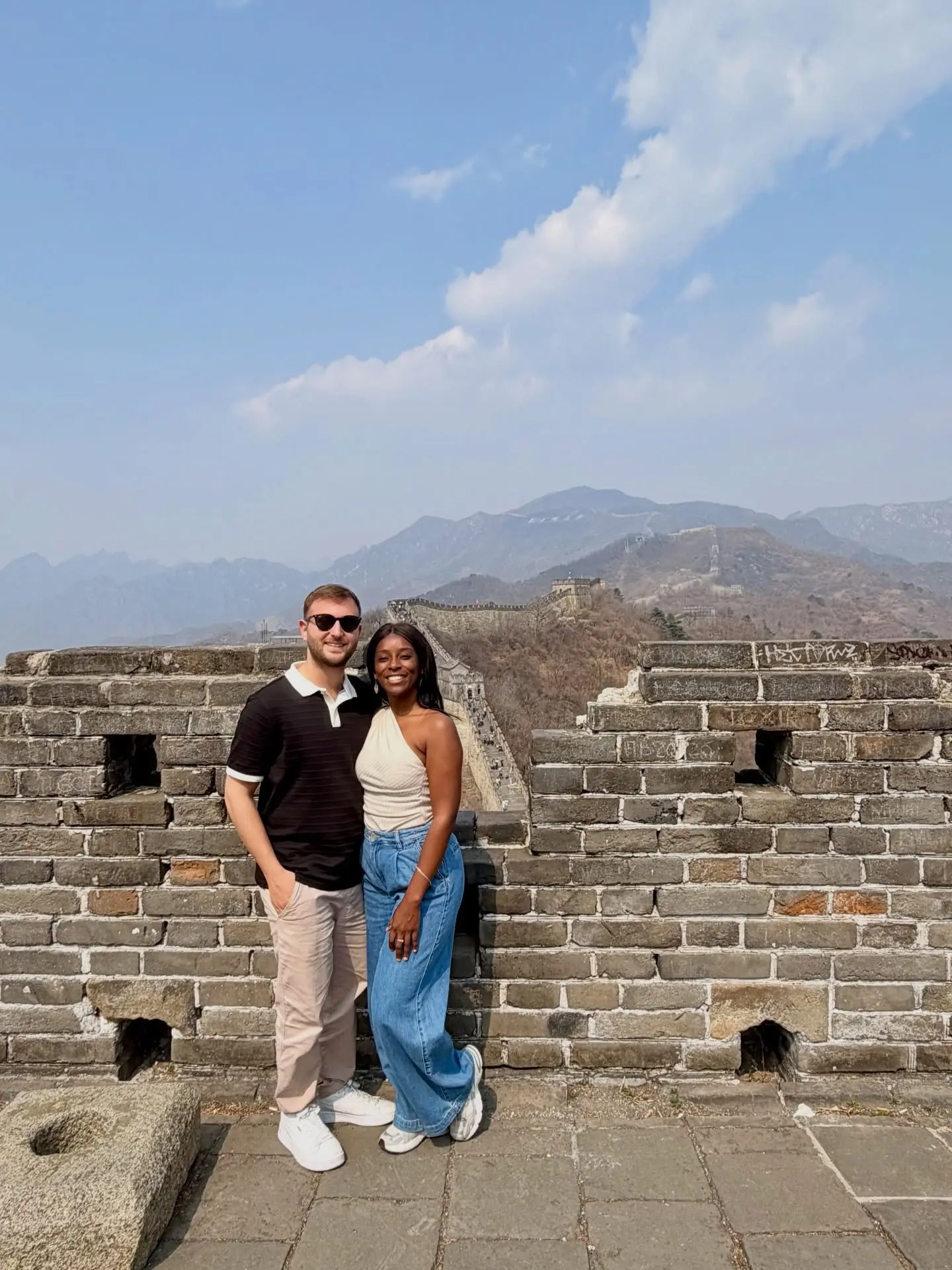 Us on the Great Wall with the mountains stretching behind