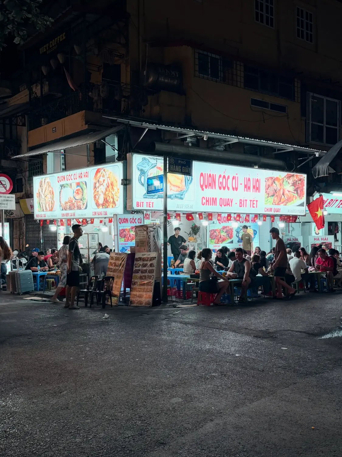 A busy Old Quarter street food corner at night