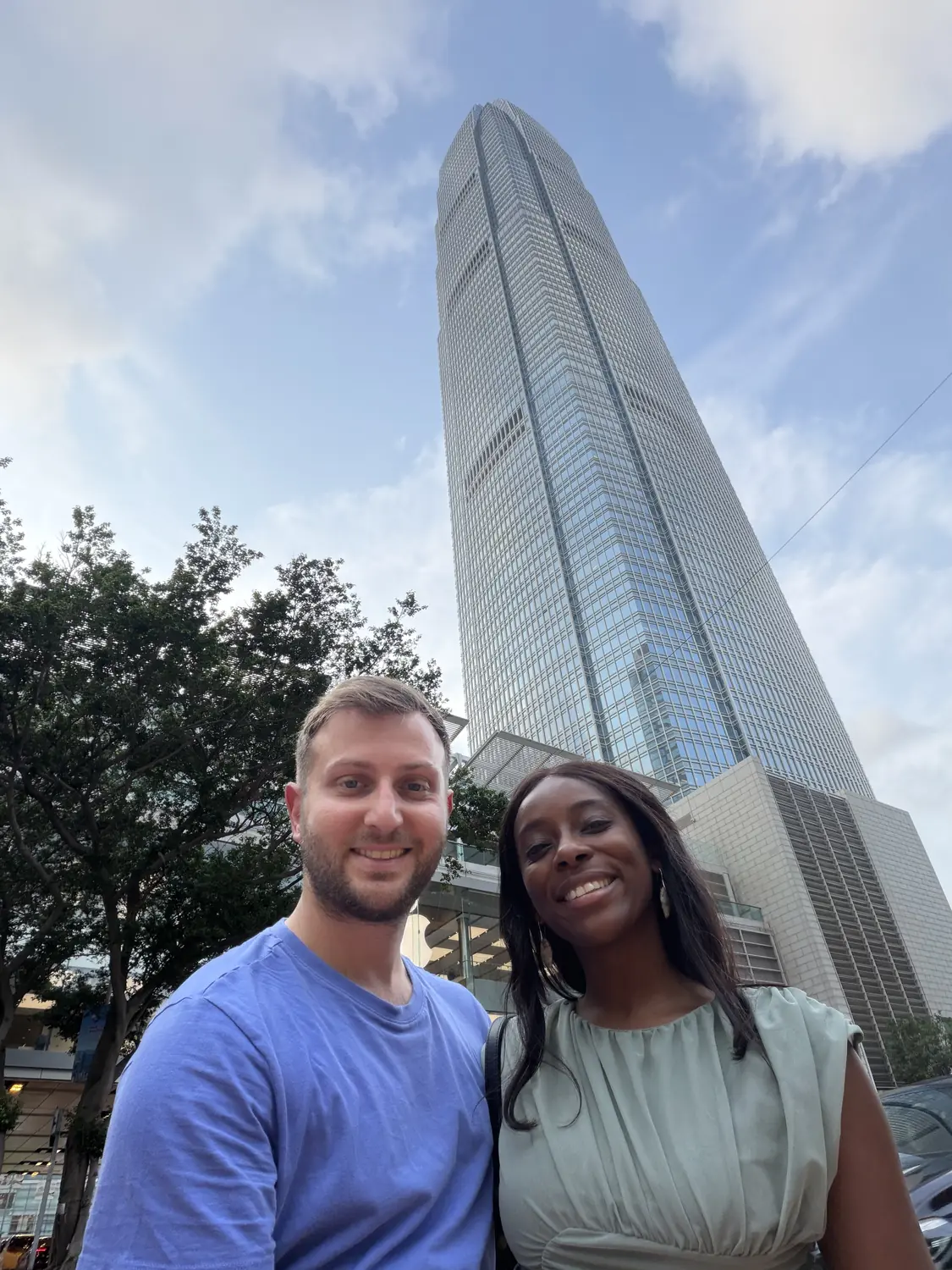 Selfie of us in front of a soaring Hong Kong skyscraper in Central