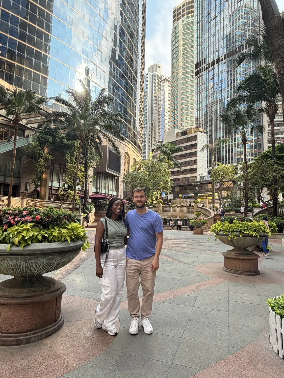 Us in the Central district of Hong Kong surrounded by skyscrapers and palms