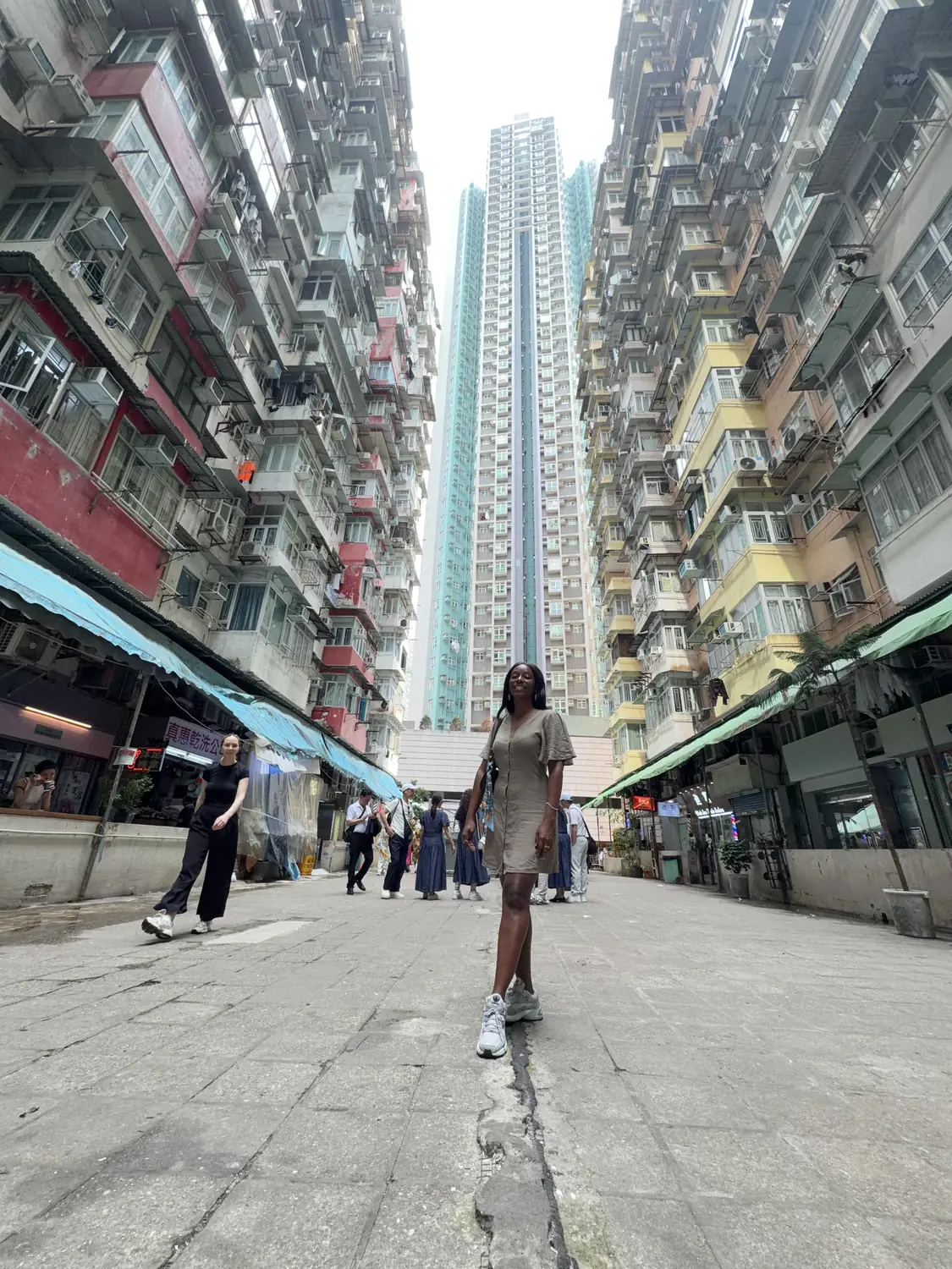 Looking up at the dense, towering apartment blocks of the Monster Building in Hong Kong