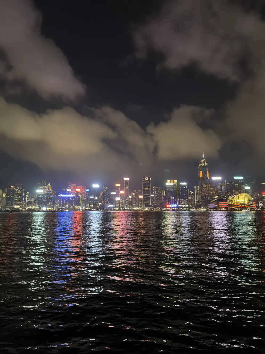 The Hong Kong skyline lit up at night across Victoria Harbour