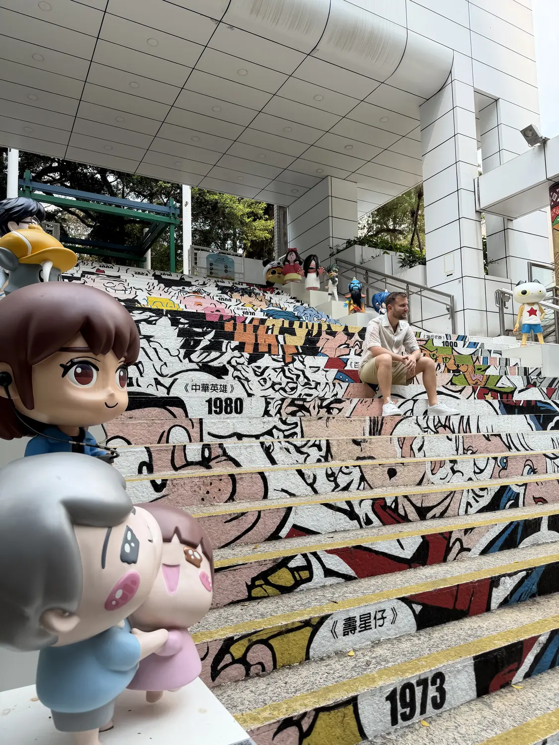 Colourful street-art staircase with figurines in Hong Kong