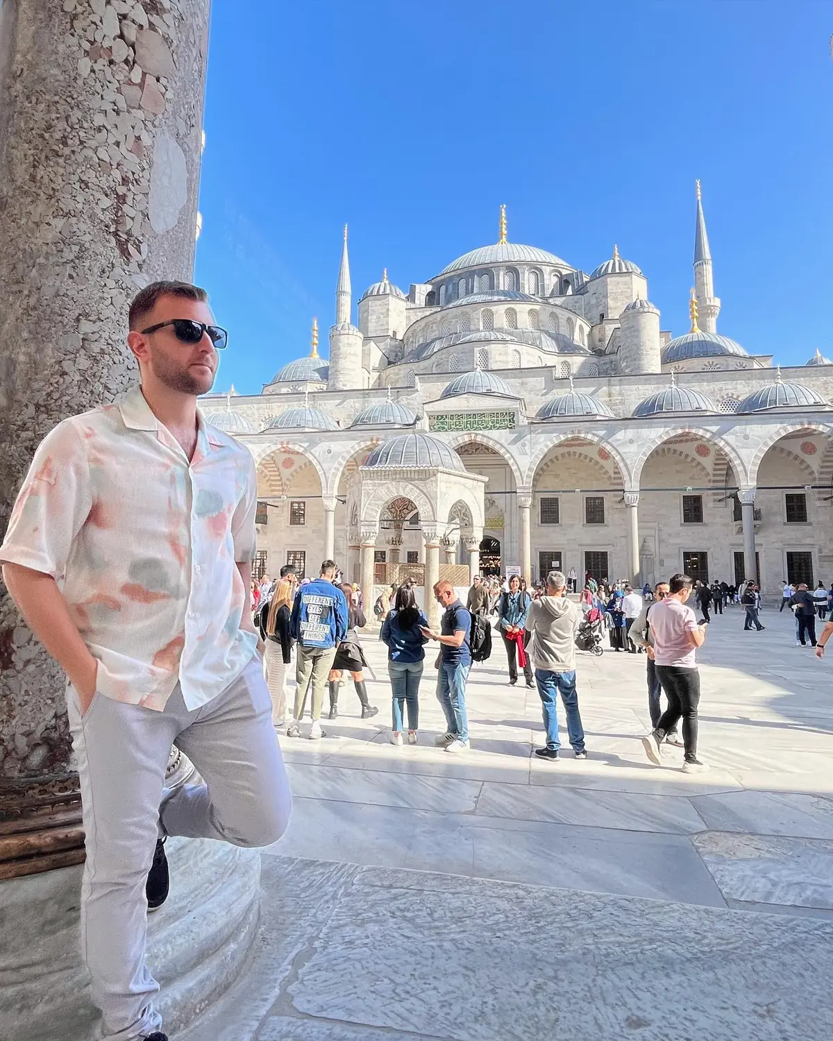 Andrew leaning on a column in the courtyard of the Blue Mosque