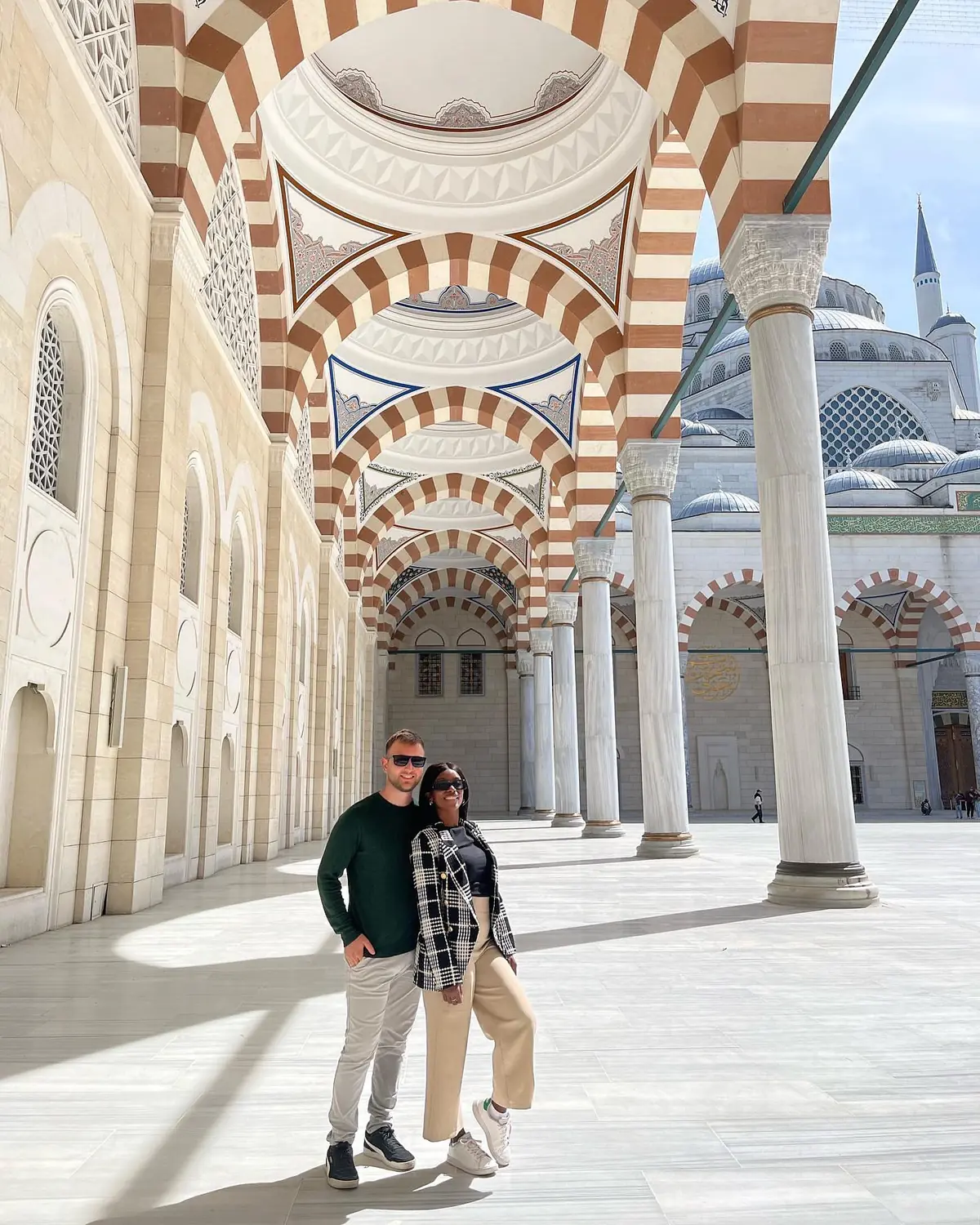 Us under the striped marble arcades of Çamlıca Mosque