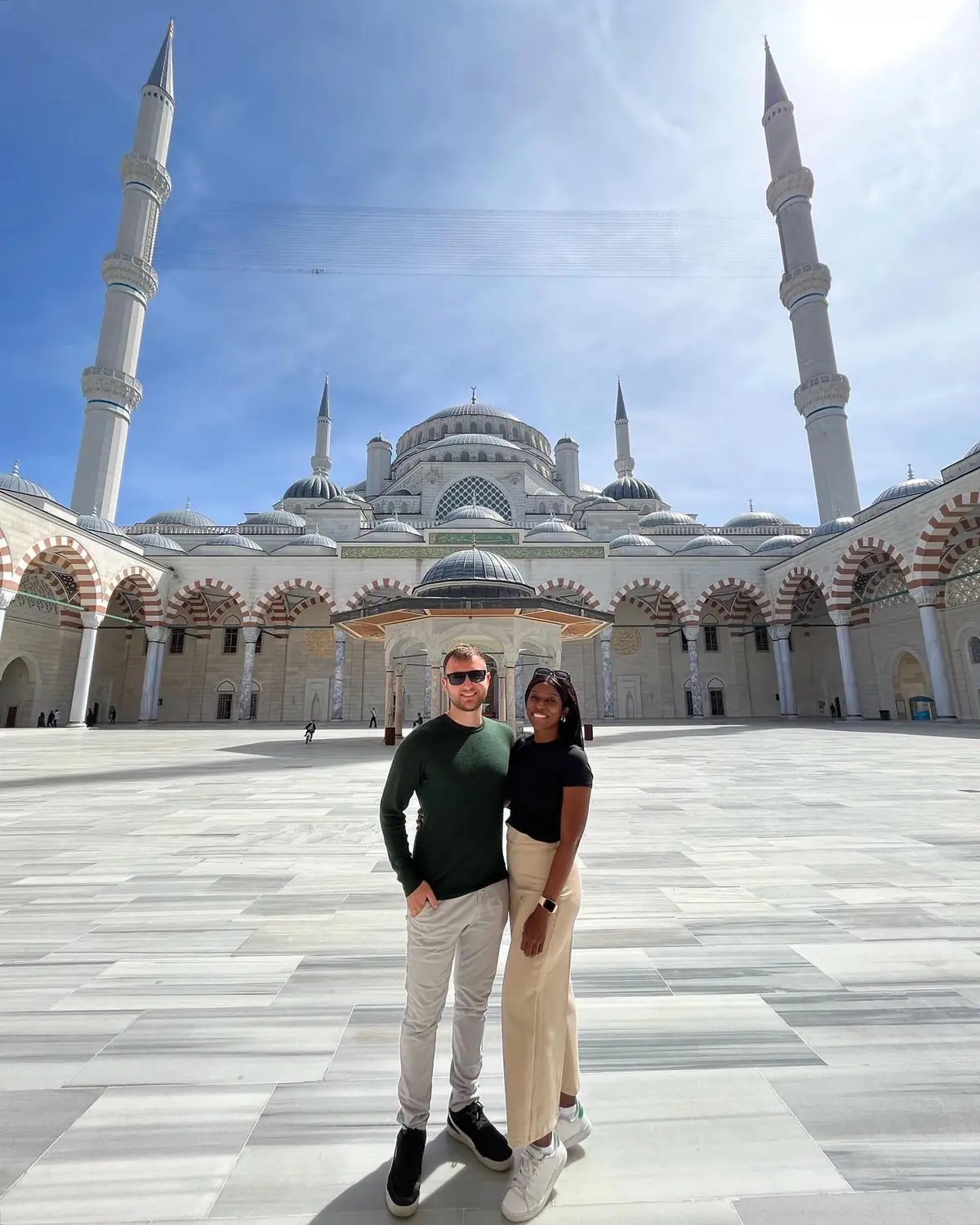 Us in the vast courtyard of Çamlıca Mosque with its minarets behind