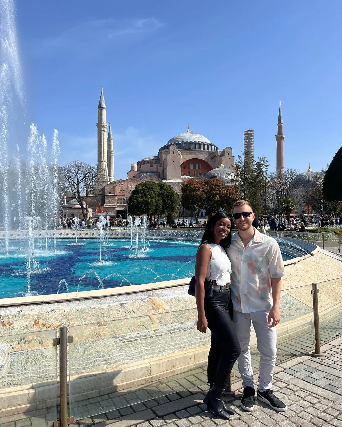 Us in Sultanahmet Square with the domes and minarets of Hagia Sophia behind