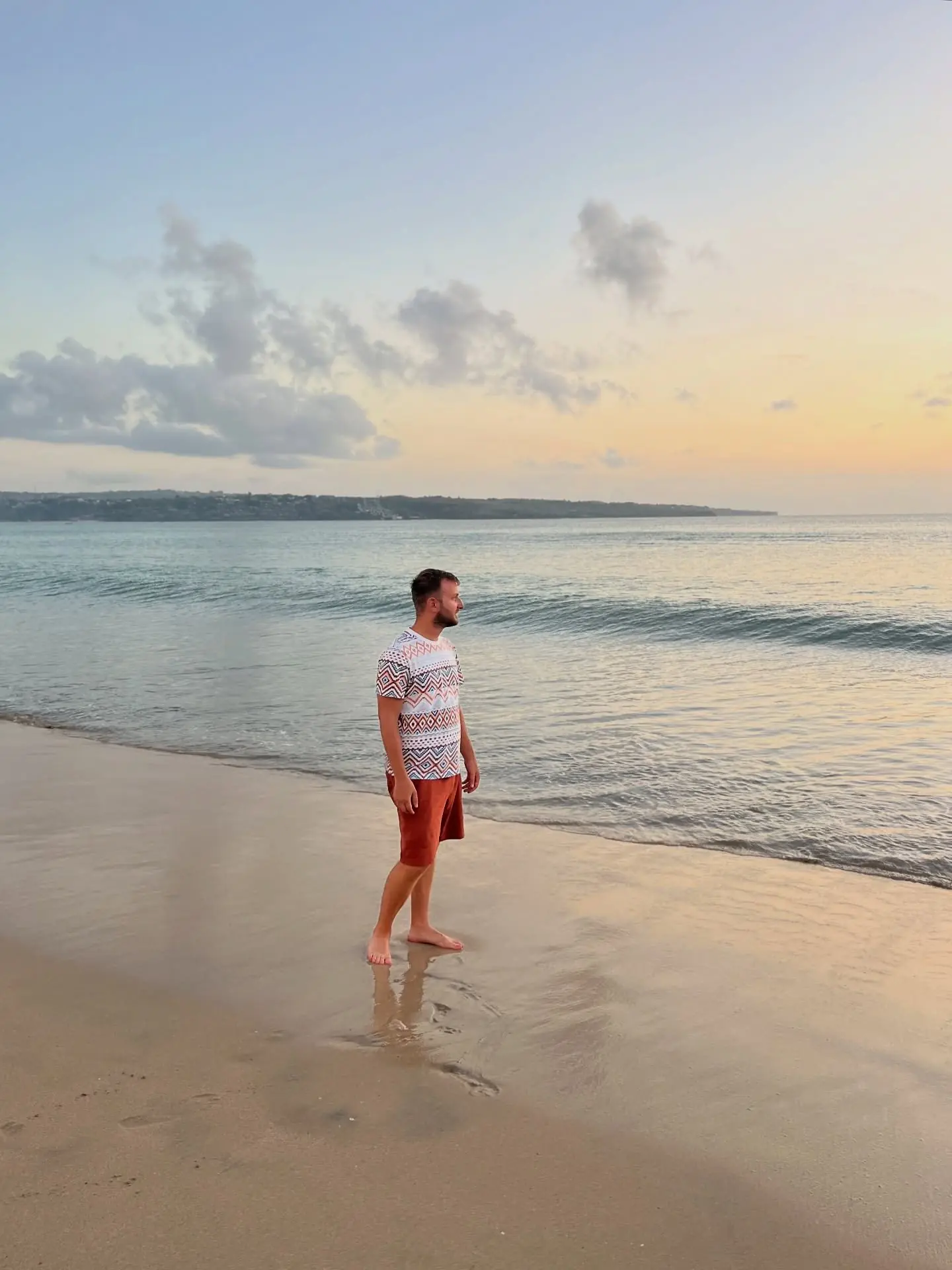 Person on a wide beach at golden sunset, South Bali