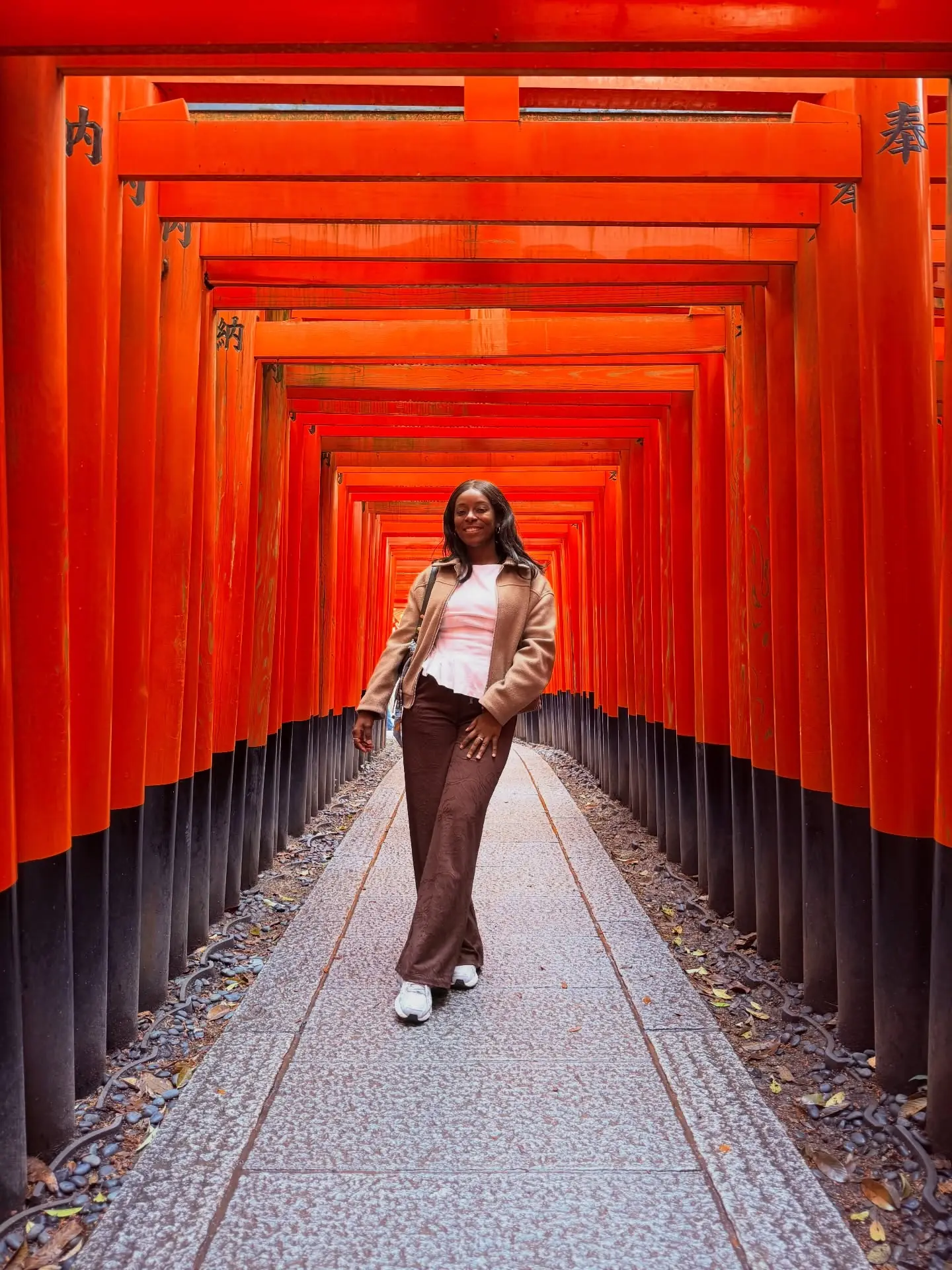 Melody walking through the endless orange torii gates at Fushimi Inari