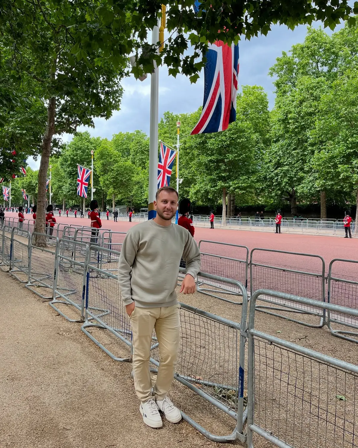 Andrew on the Mall lined with Union Jack flags and King's Guards in red