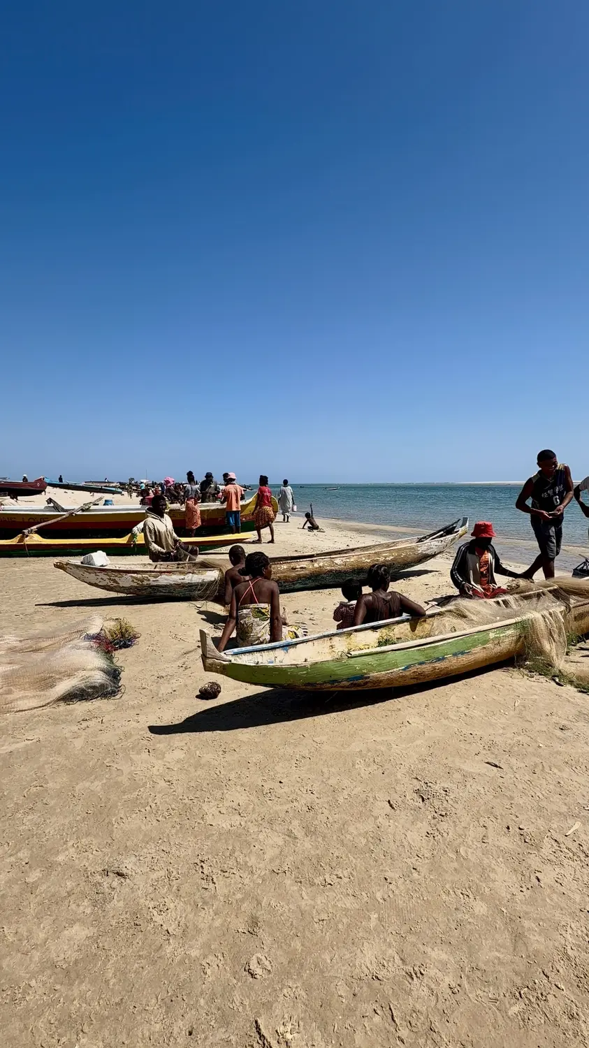 Fishing families and outrigger pirogues pulled up on the sand at Betania