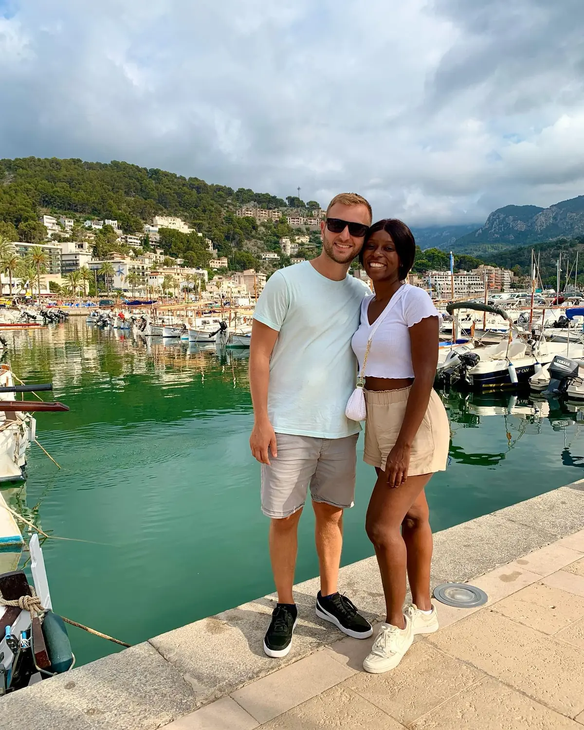 Us on the harbourfront at Port de Sóller with fishing boats and green mountains behind, Mallorca