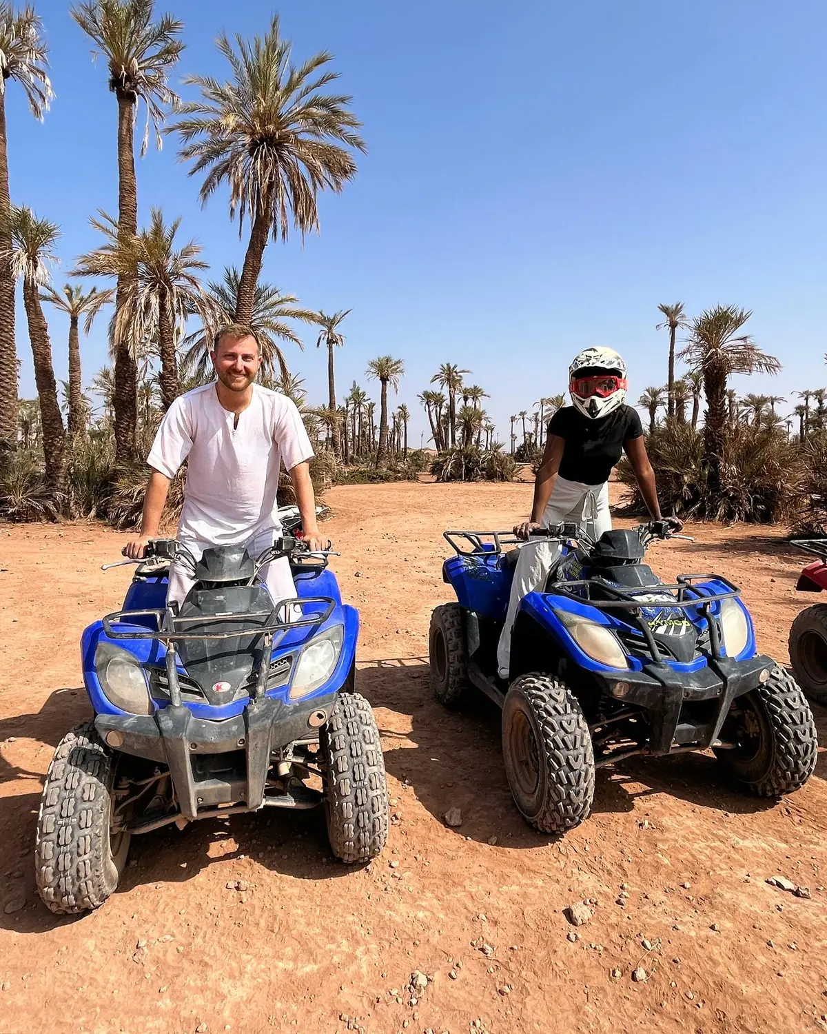 Us on blue quad bikes among the palm trees of the Palmeraie