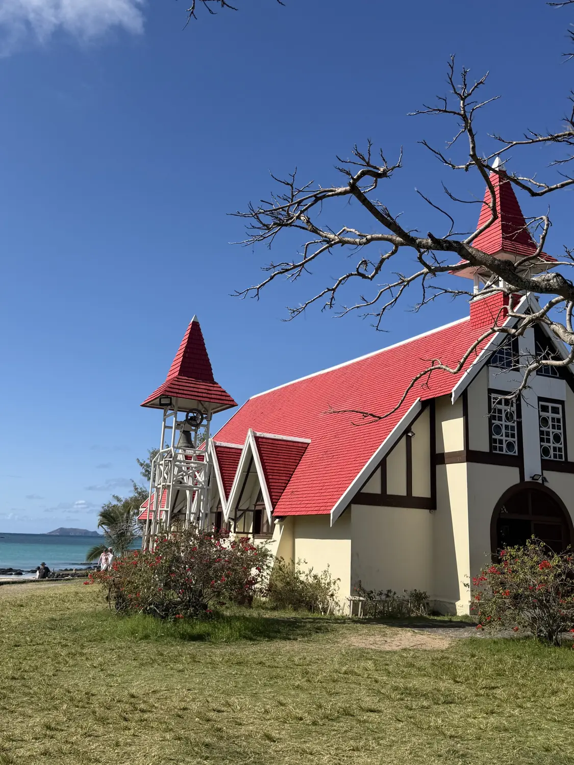 The red-roofed Notre-Dame Auxiliatrice church at Cap Malheureux beside the sea