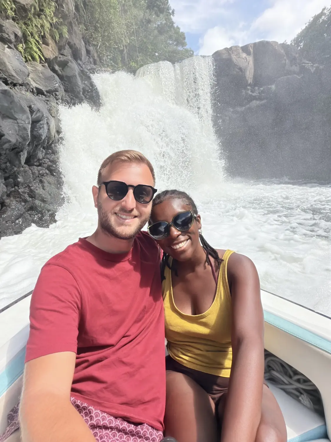 Us smiling on the speedboat right in front of the roaring GRSE waterfall
