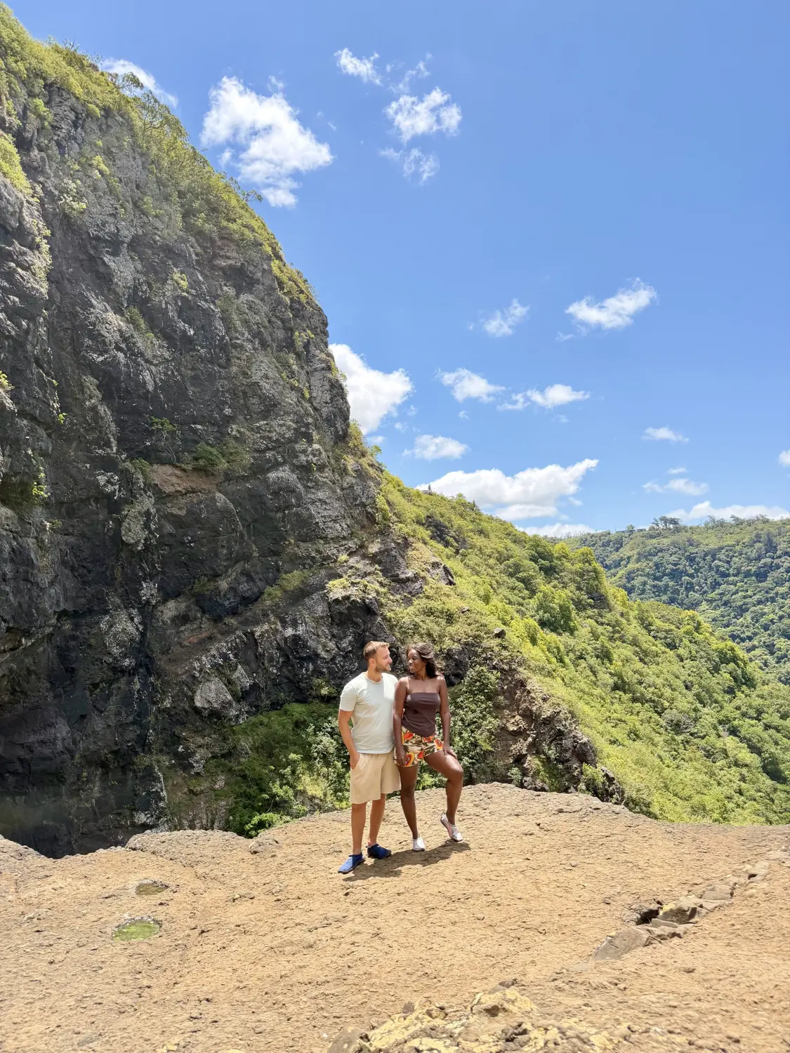 Us standing together on a clifftop ledge above a deep green gorge