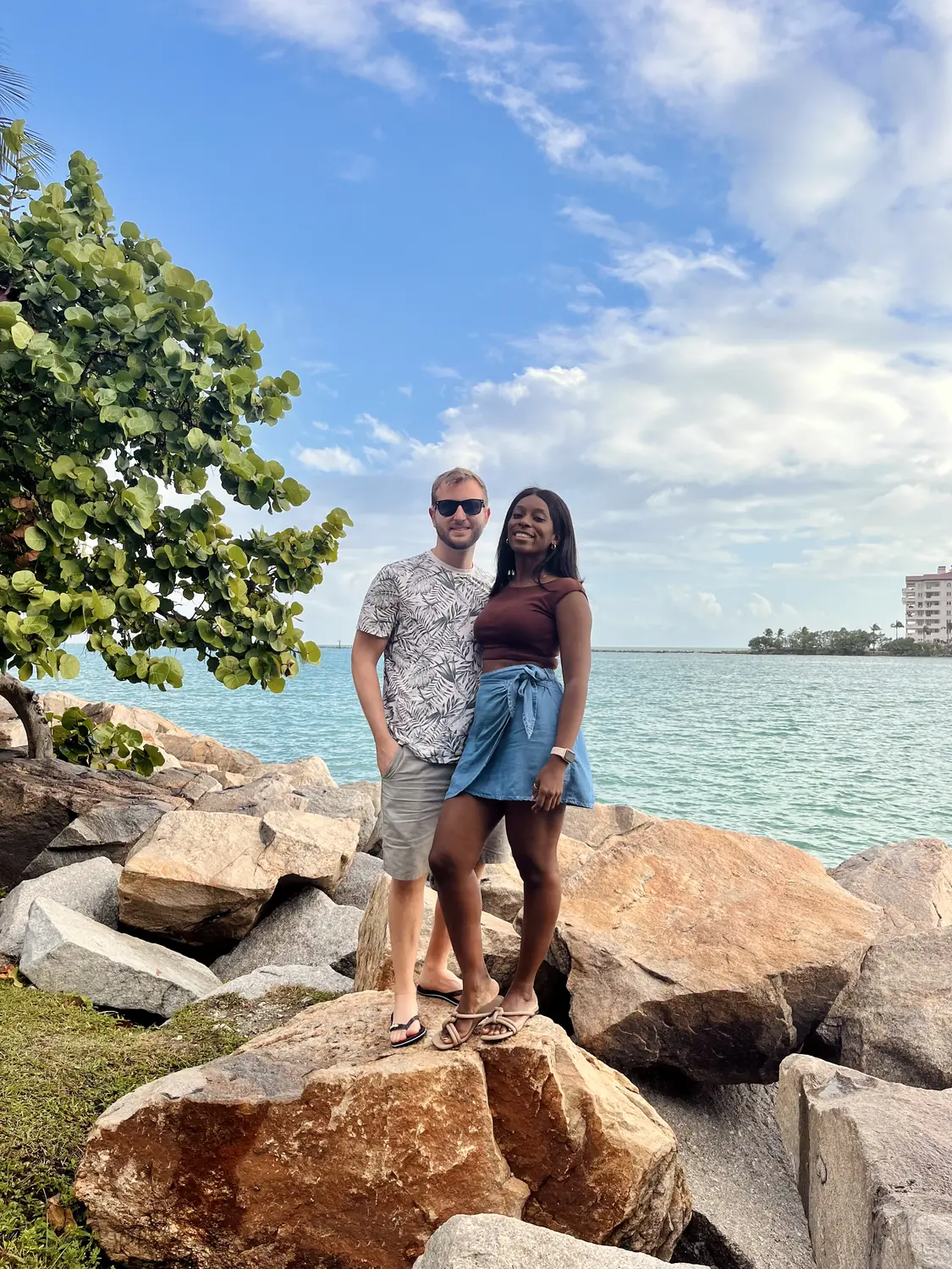 Us standing on rocks beside Biscayne Bay in Miami