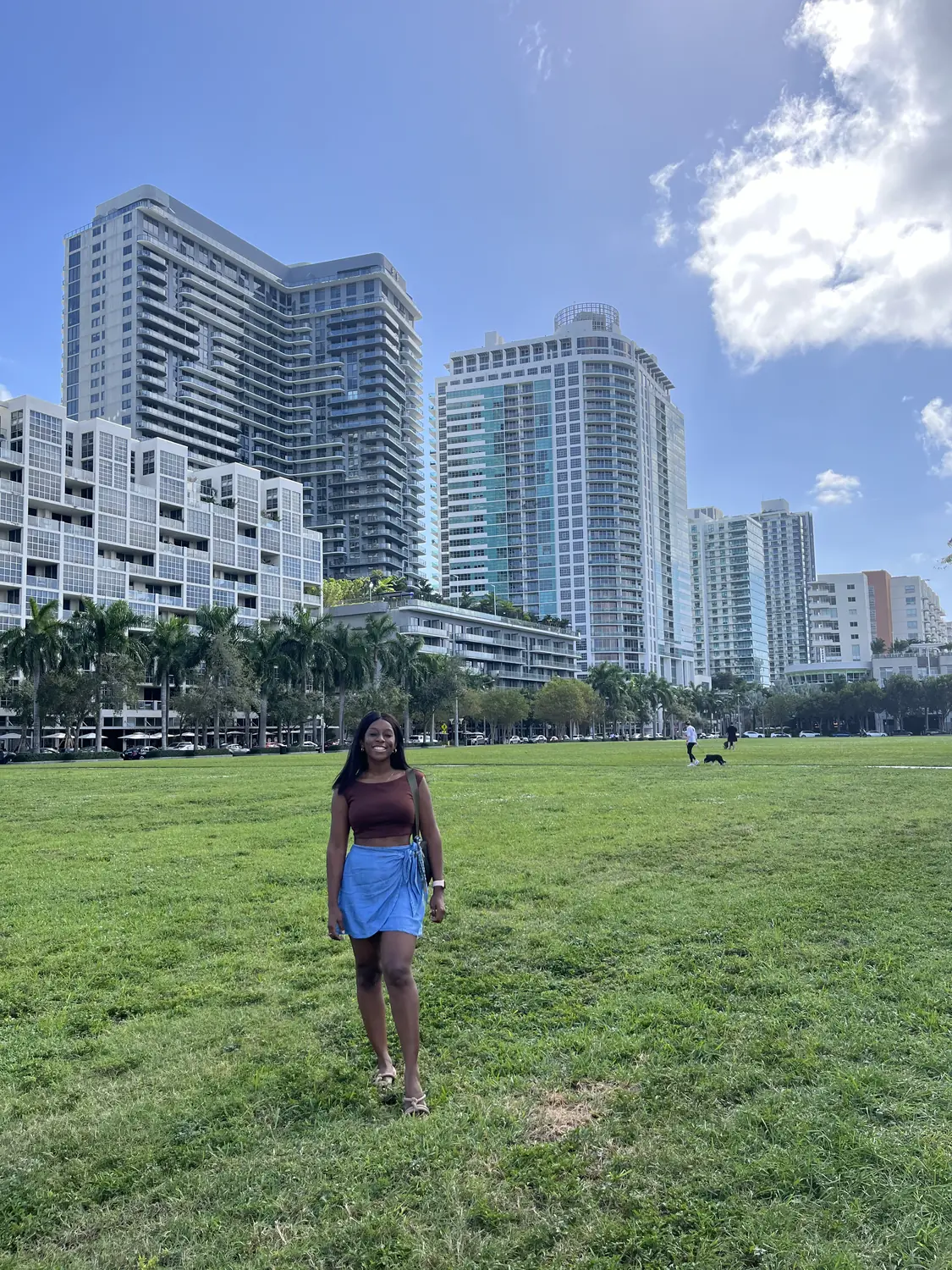 Melody on a lawn with the downtown Miami skyline behind
