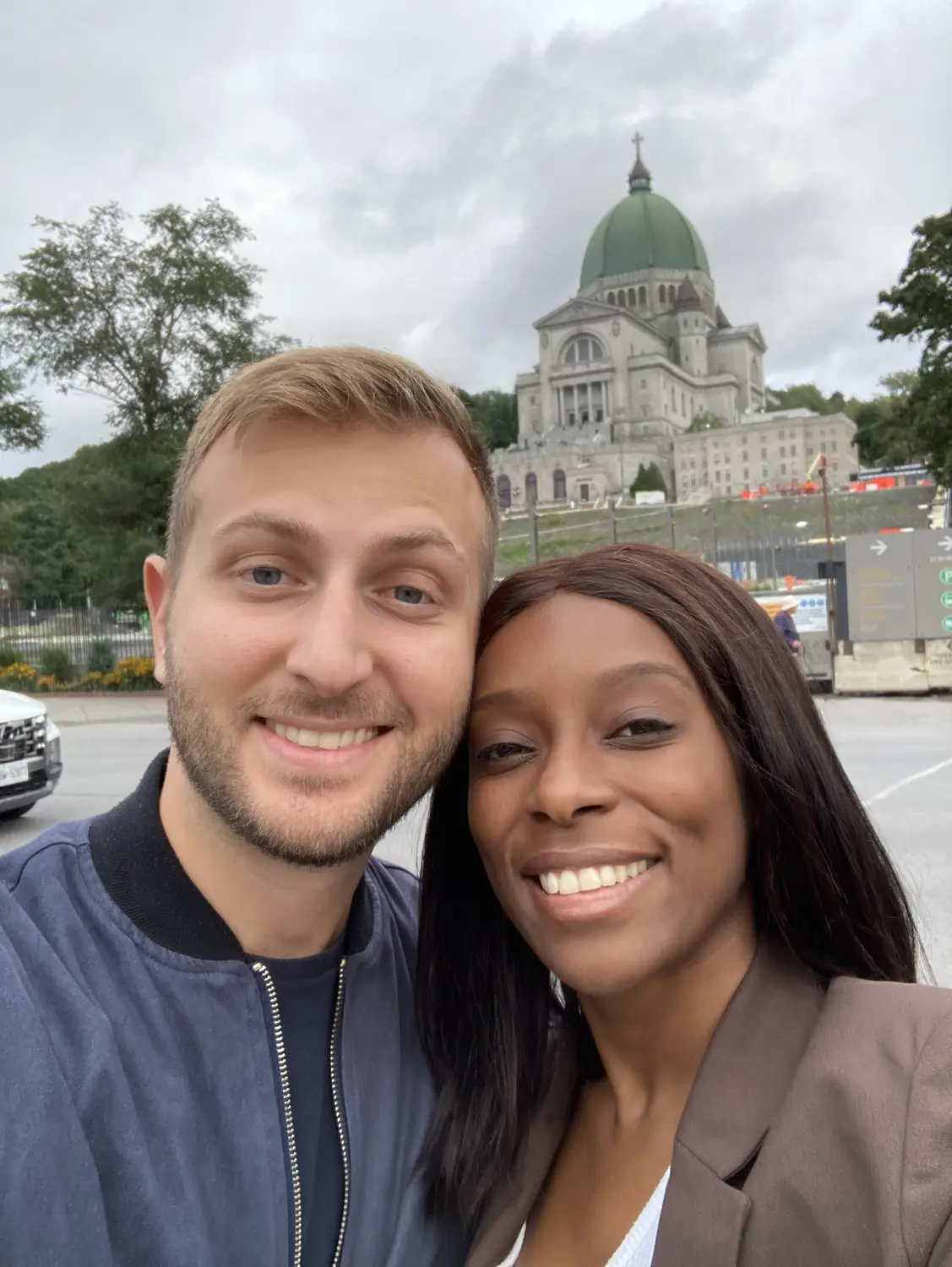 Us smiling in front of Saint Joseph's Oratory in Montreal