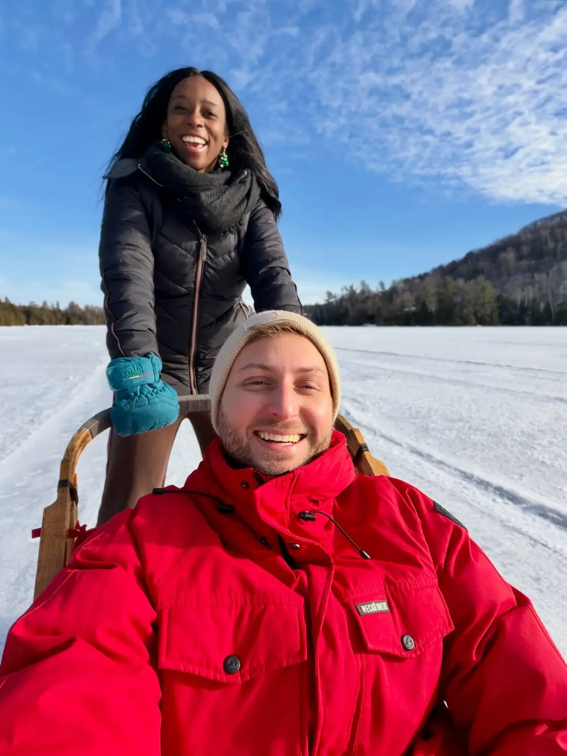 Selfie of us on a dog sled on a sunny frozen lake near Saint-Sauveur